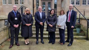A picture of Stranmillis University College's new Visiting Professors meeting the team from CREU, in front of the steps of Stran House.