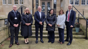 A picture of Stranmillis University College's new Visiting Professors meeting the team from CREU, in front of the steps of Stran House.